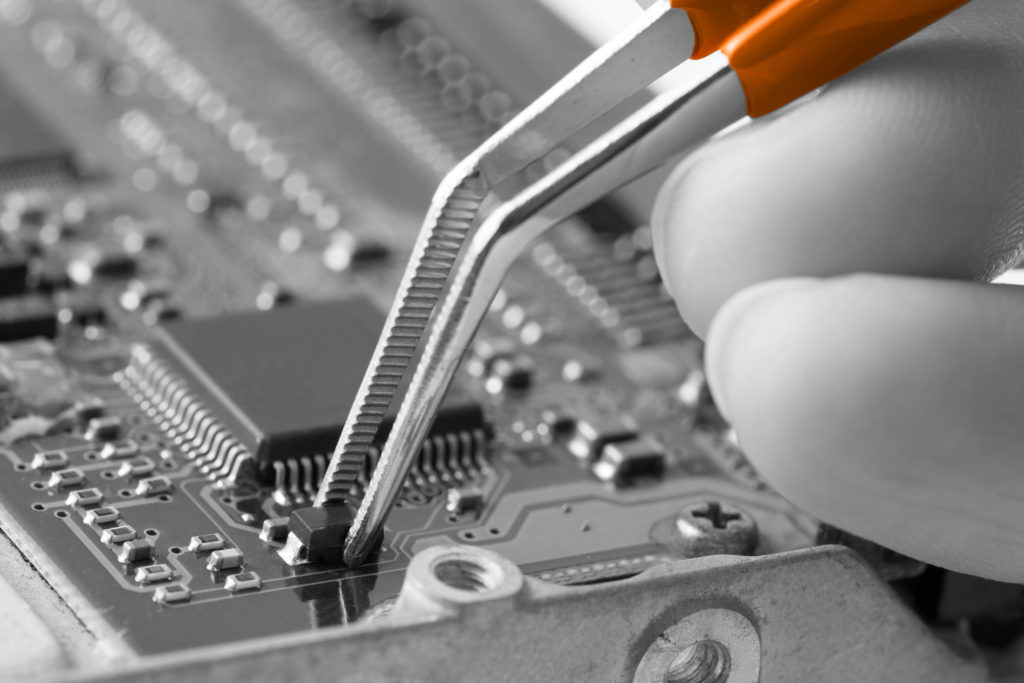 This image shows a circuit board prototype being assembled